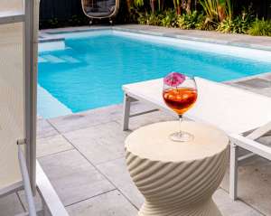 Luxury swimming pool reflecting sunset colors with modern pool lights on, photographed by Forma Media in Melbourne.